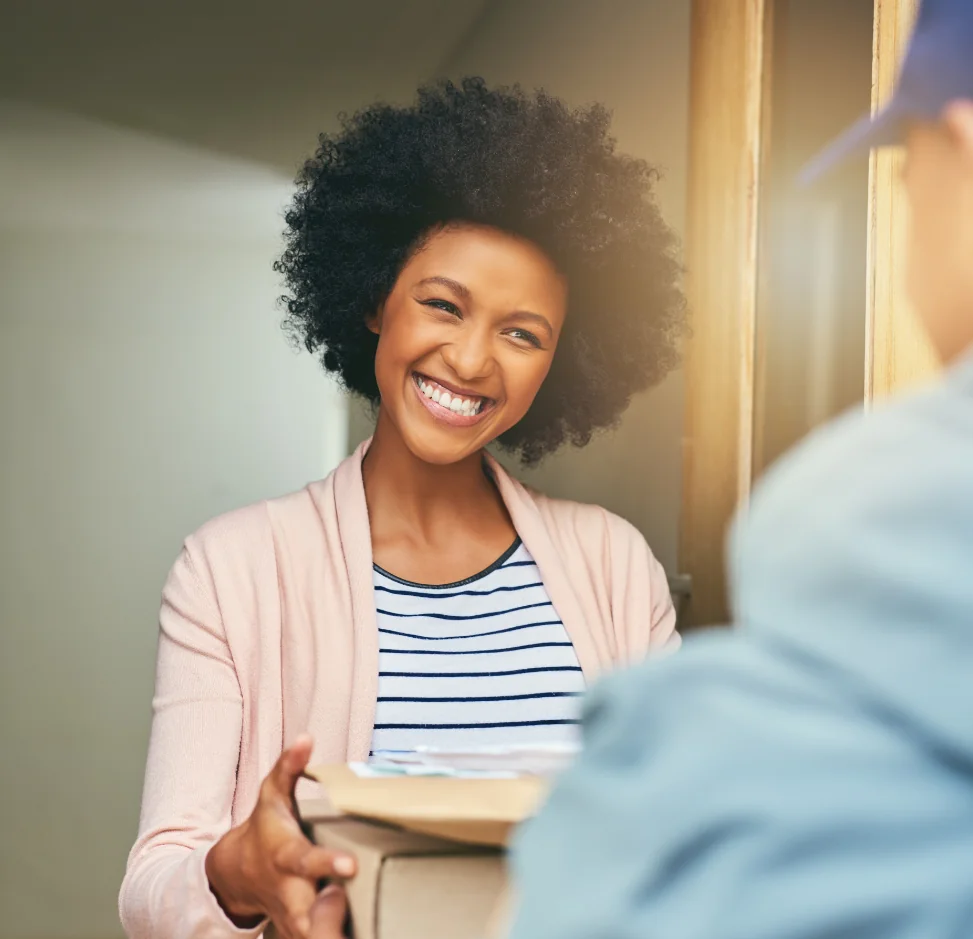 woman receiving a delivery of medicines from driver
